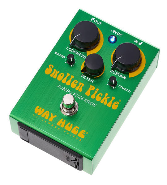 Green fuzz effects pedal angled view with three black knobs and silver footswitch