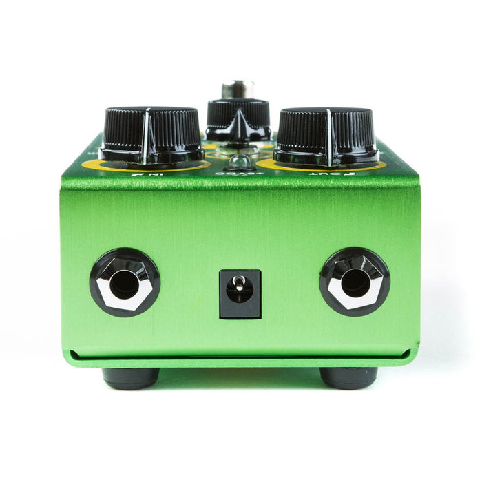 Green guitar fuzz pedal close-up with three black knobs and metal bypass switch