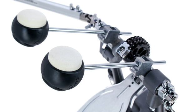 Double bass drum pedal beaters with black caps and metal rods over the base plate